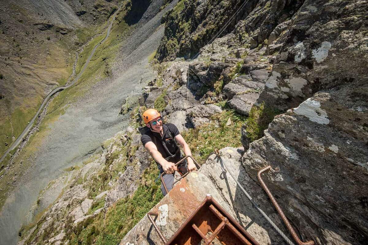 looking down on a man abseiling down a cliff