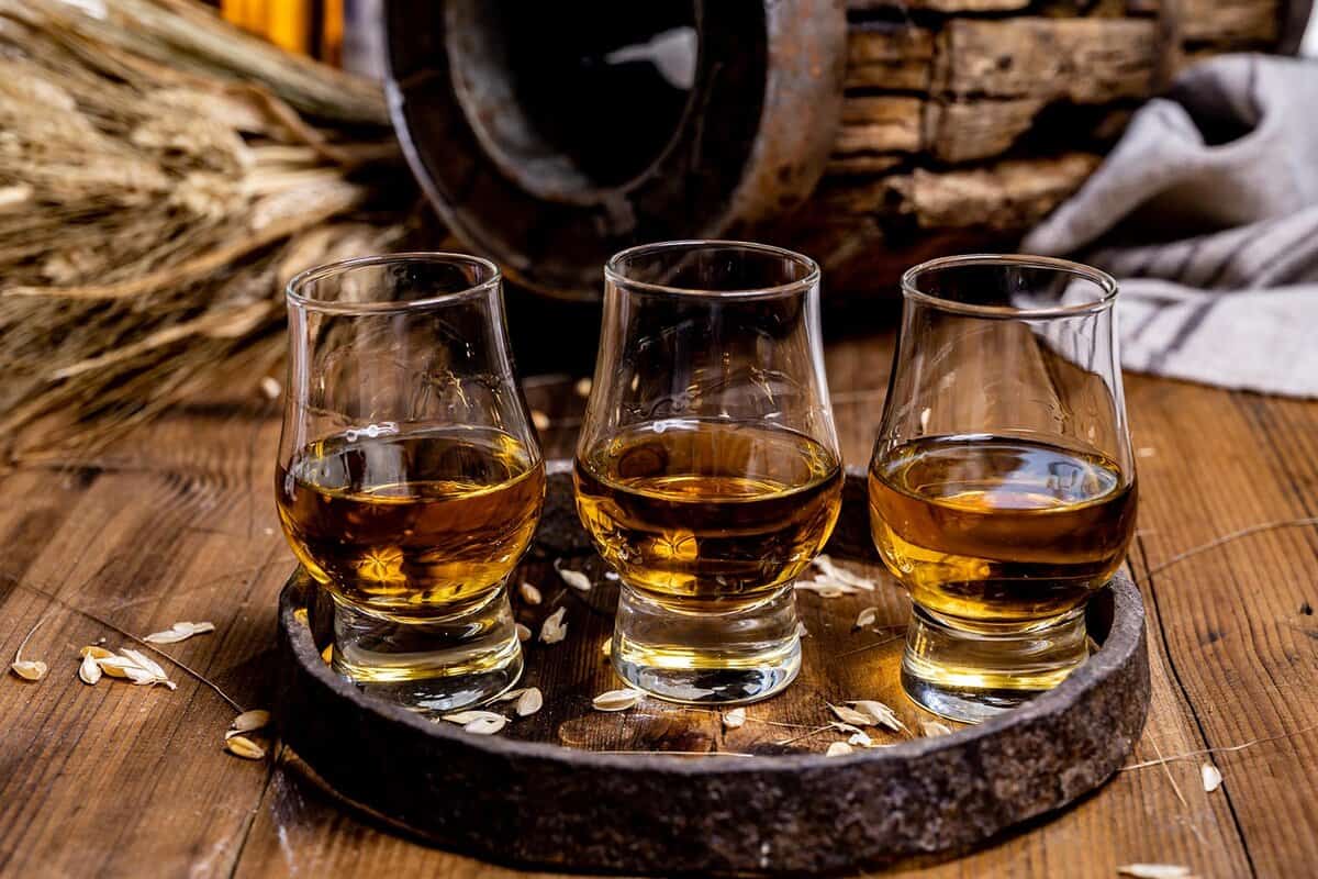 three small glasses of whisky