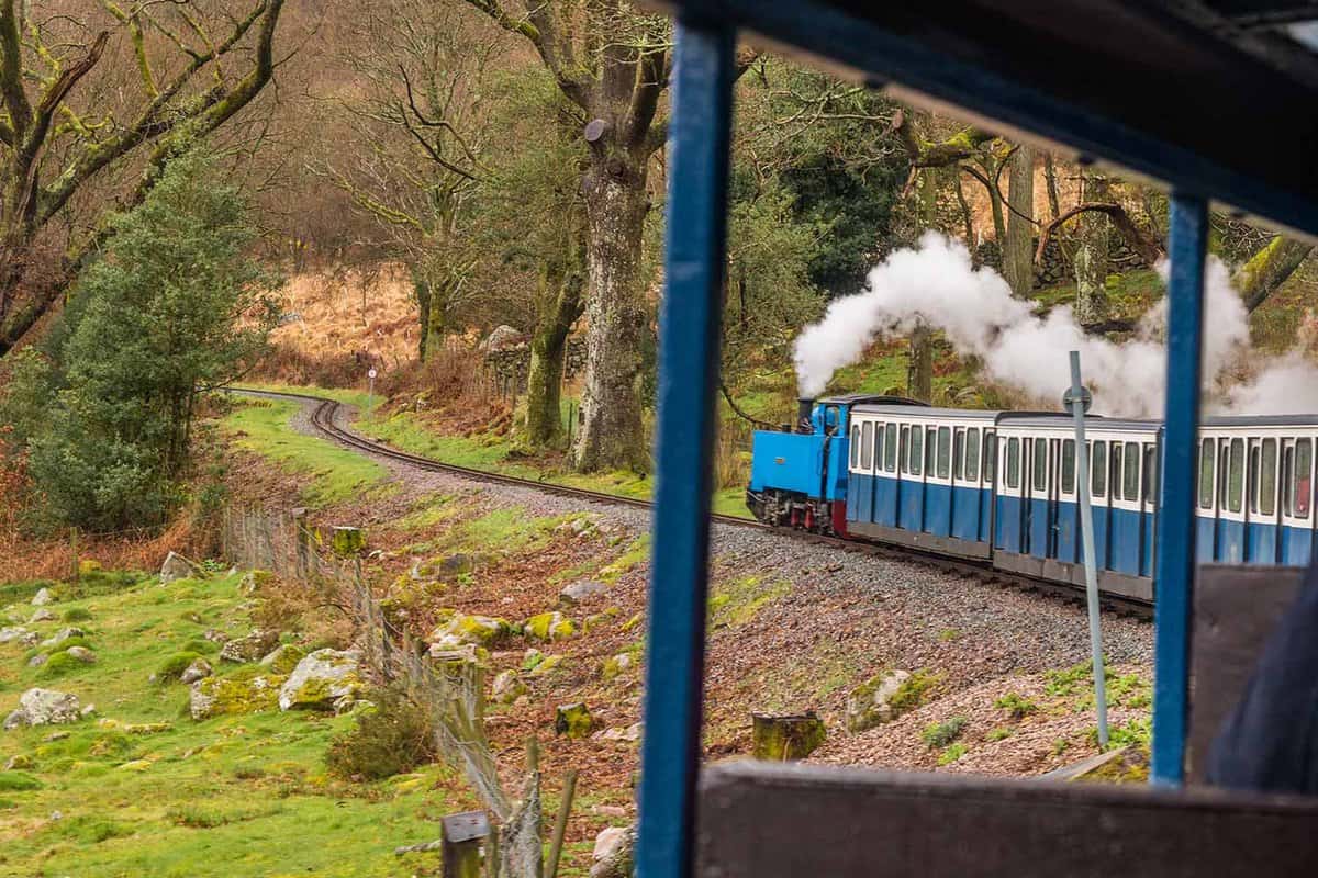 View from out of a carriage of the train to see the steam engine at the front
