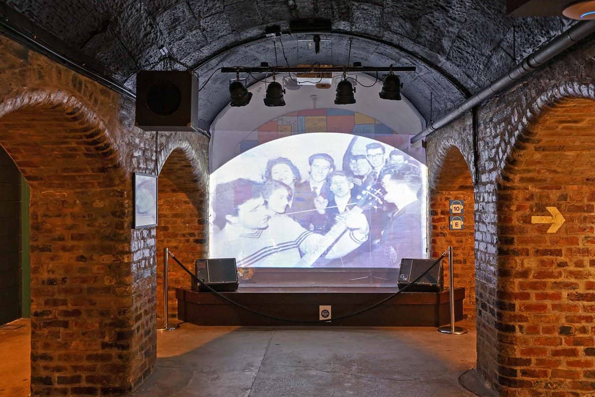 Screen showing a film of the fab four