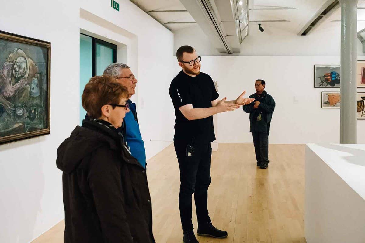 Guide giving a talk on some artworks
