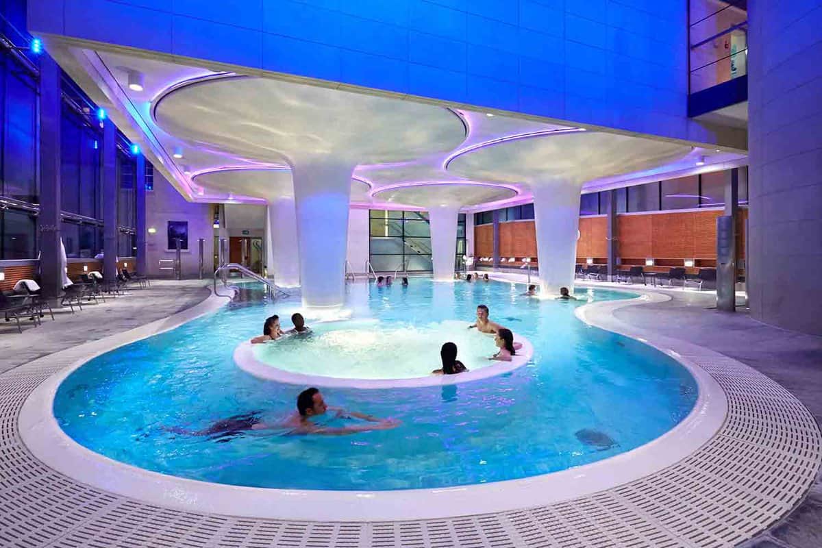 Circular jacuzzi bath with people sitting in it