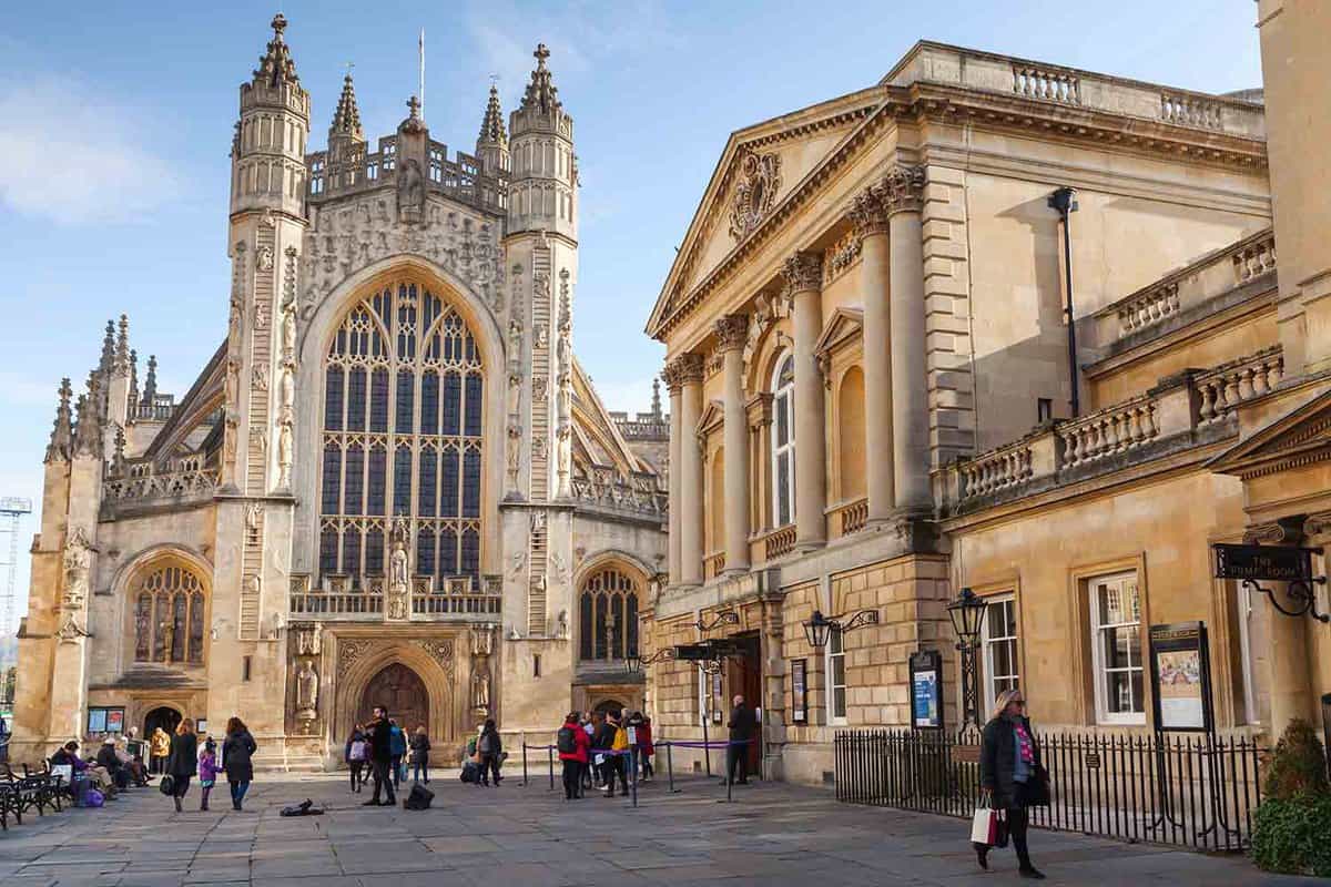 Exterior front facade of beautiful abbey in golden bath stone