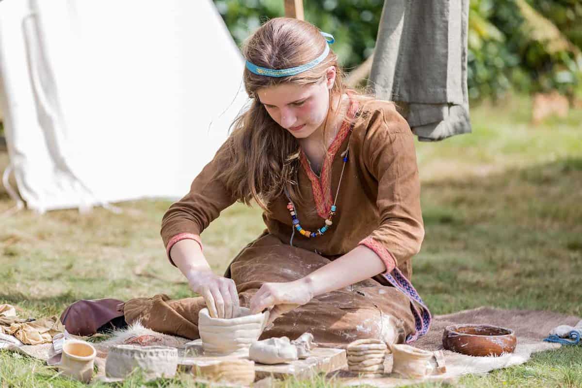 Anglo-saxon clay pottery maker sitting at the national park