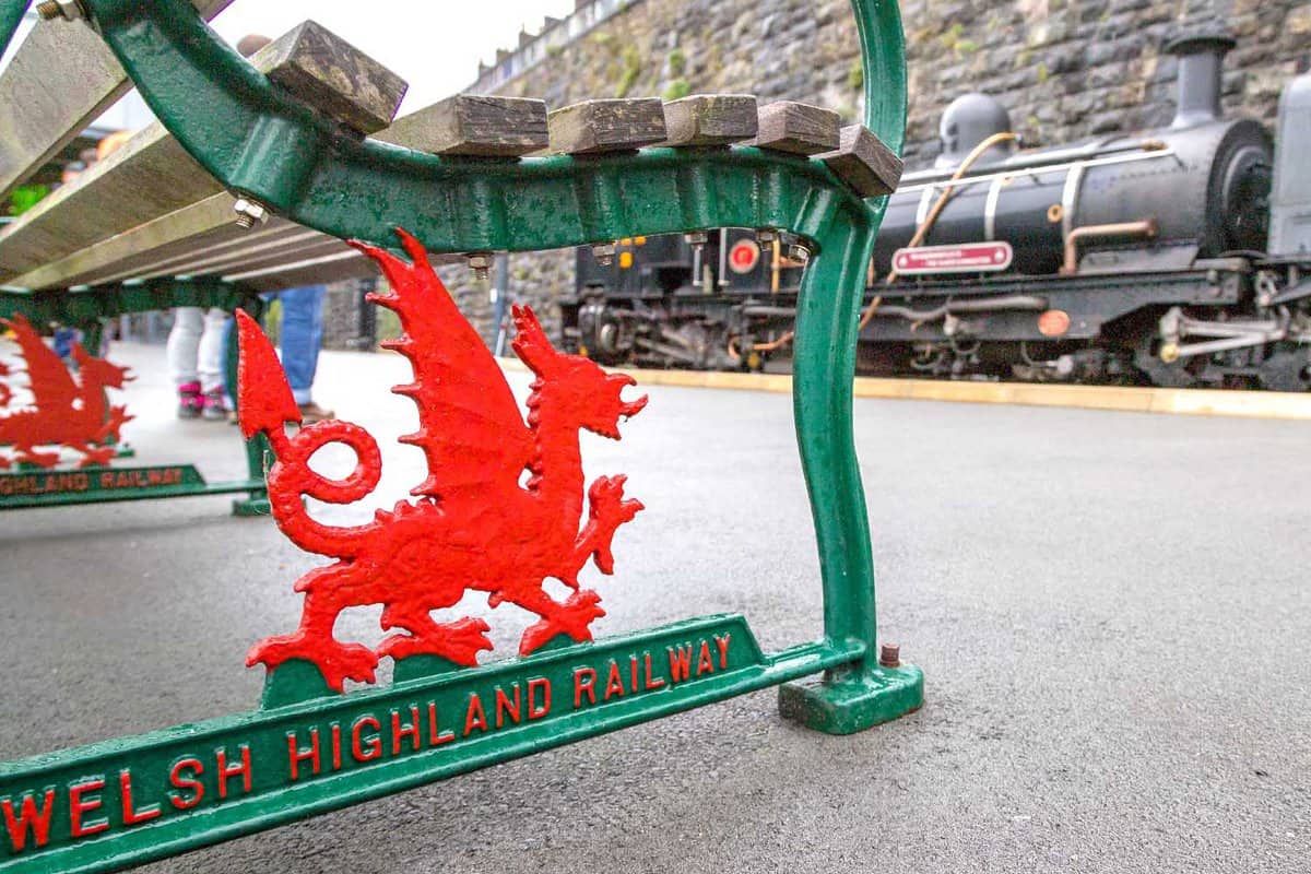 Red dragon metalwork under a bench on the Welsh Highland Railway station in Caernarfon, North Wales