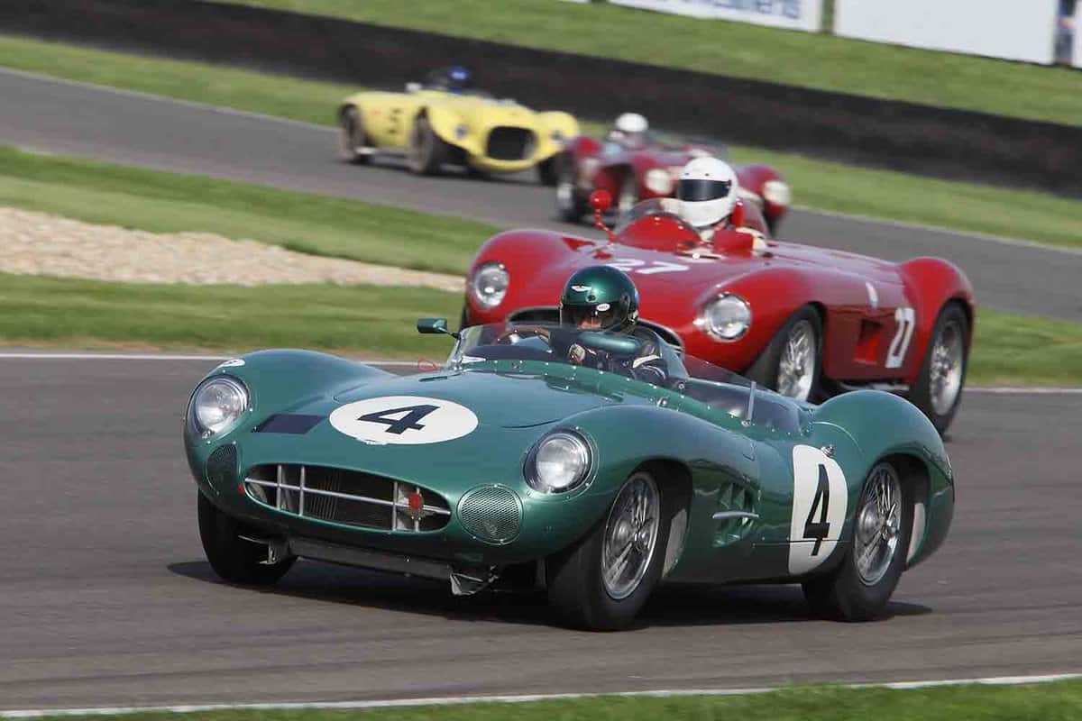 Unidentified drivers competing in classic sportscars at the Goodwood Revival event 20 September 2008 at the Goodwood Circuit. A green sports car overtaking a red car on the racing track.
