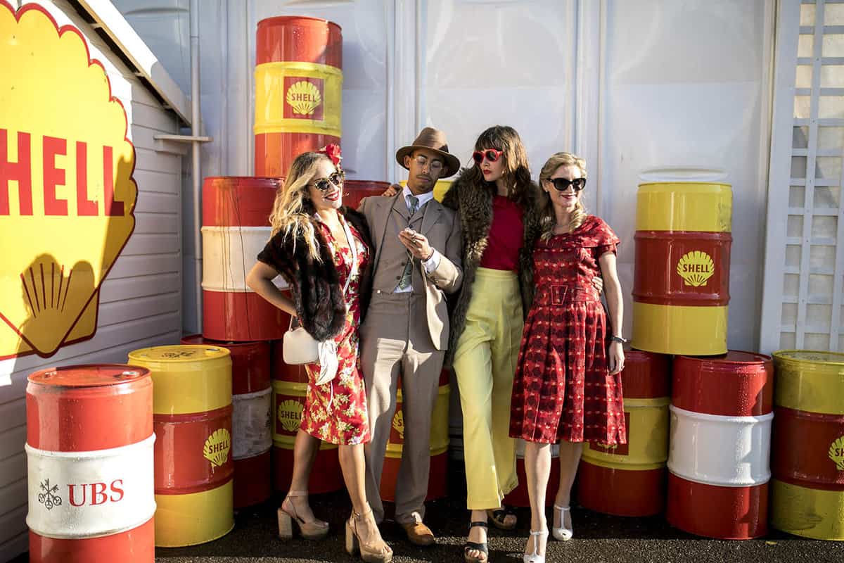 group of people dressed up in colourful vintage clothes