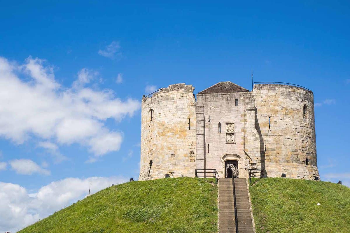 Hill-top fortified tower on a sunny day with stairs leading up to it