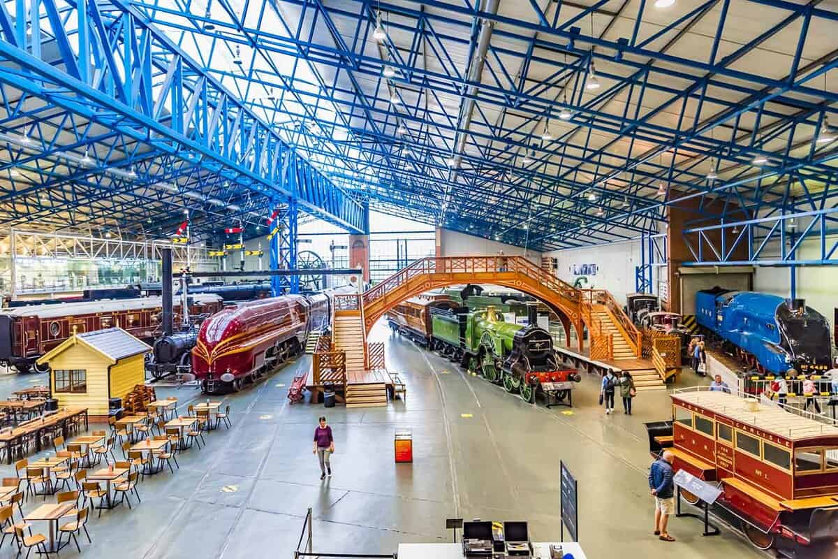 View inside main exhibition hall of museum showing various trains and engines