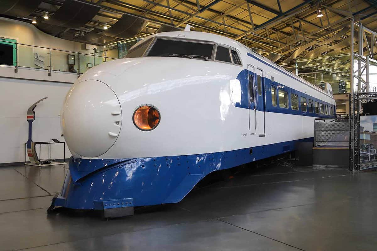 A locomotive of a white Japanese bullet train with a blue trim