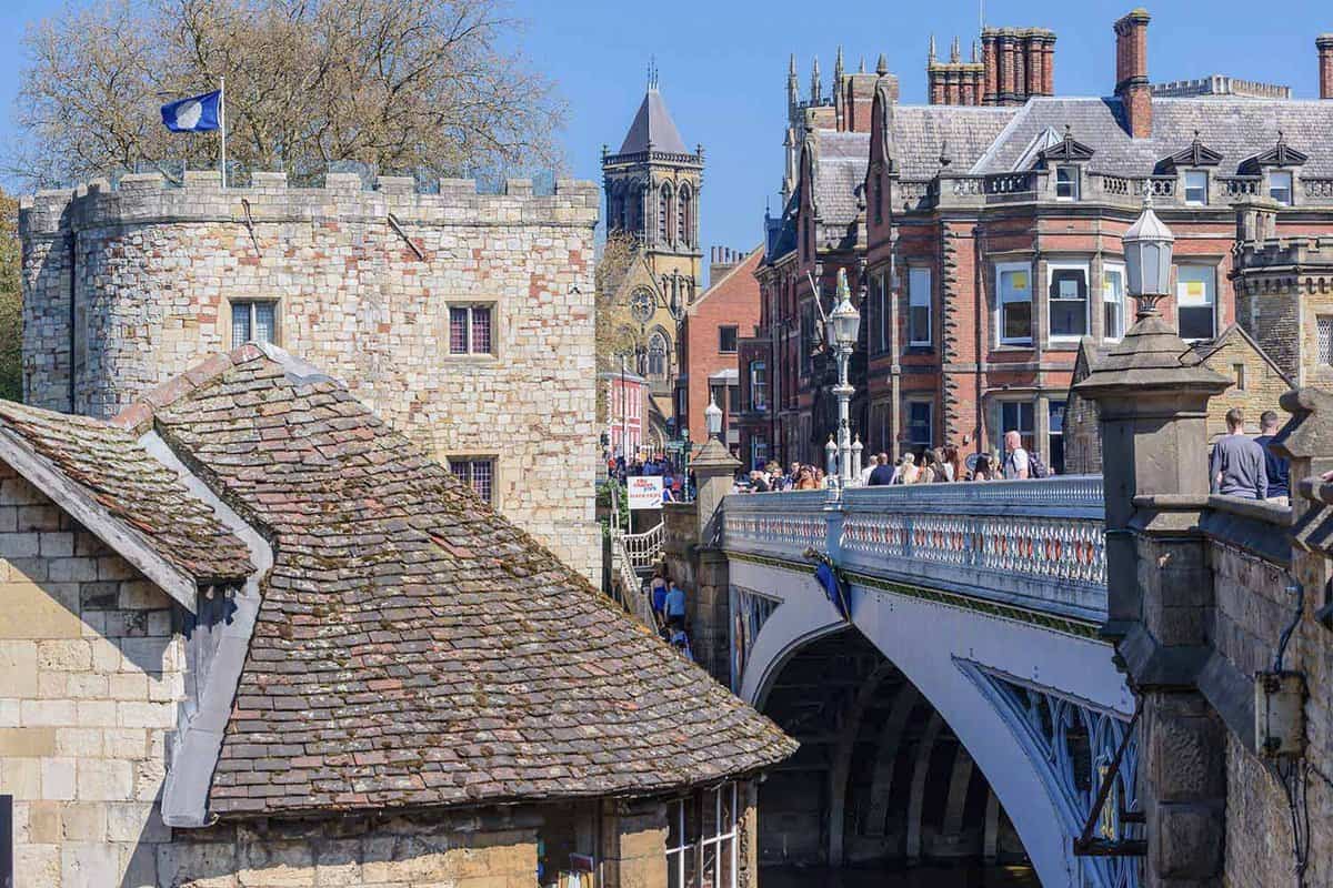 Bridge over the River Ouse with catholic church and old city in the background on a clear day