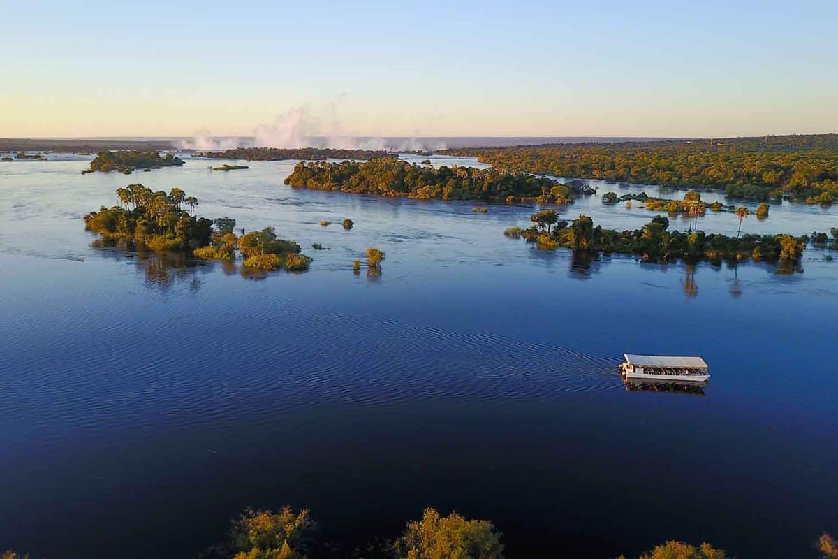 a shot from above of the zambezi river and cruise boat