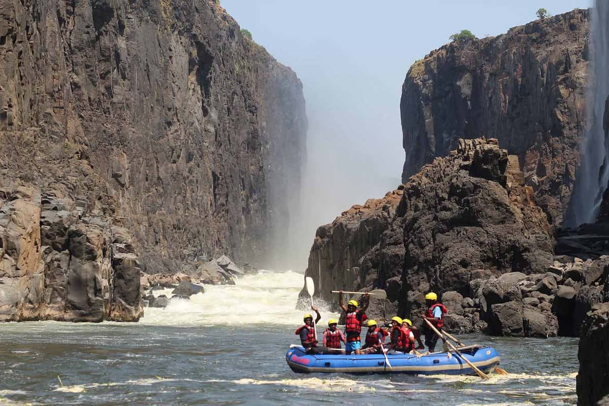 A raft on the Zambezi with a backdrop of the Batoka Gorge