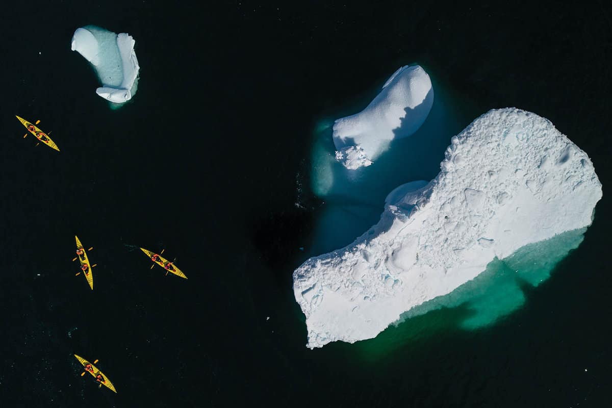 Aerial view of kayaks and an iceberg
