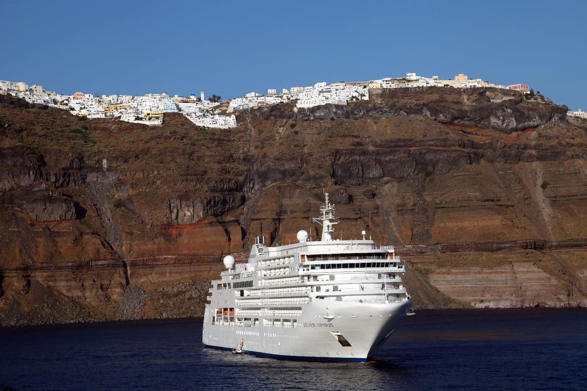 Large cruise ship before cliffs on Santorini