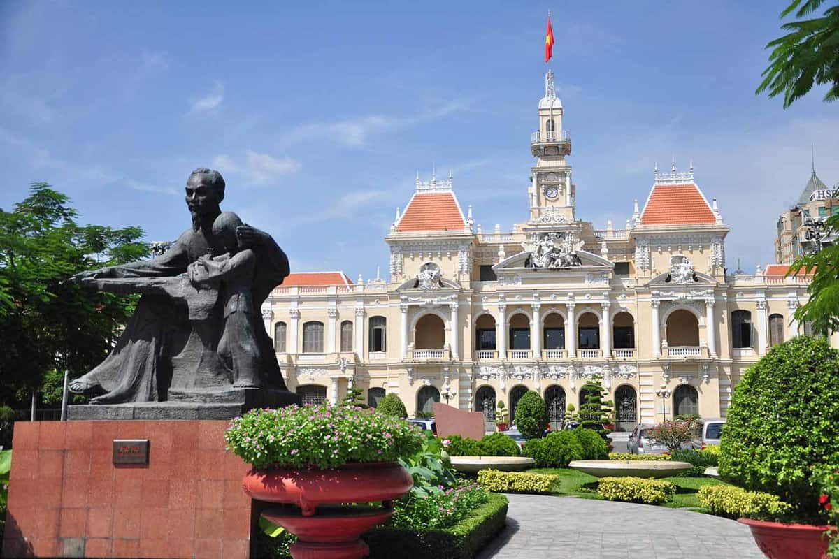 external facade of the building with statue of Ho Chi Minh in front
