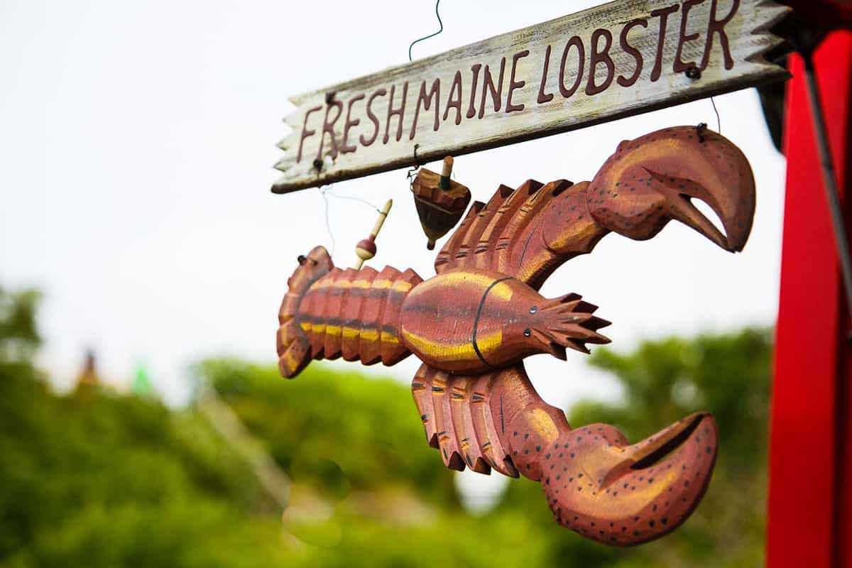 wooden lobster sign outside of a restaurant