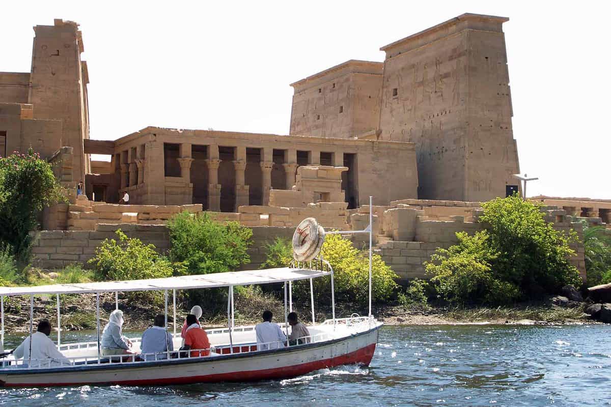 Small tourist boat with the temple looming up behind