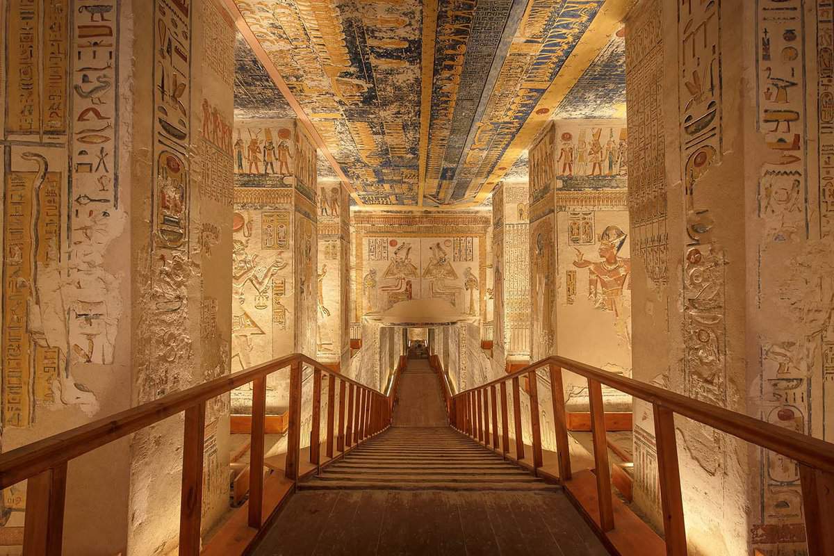 walkway between walls covered in hieroglyphs