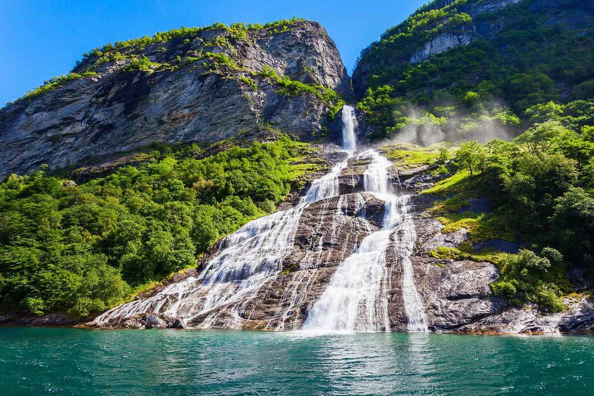 a waterfall cascading down the side of a fjord