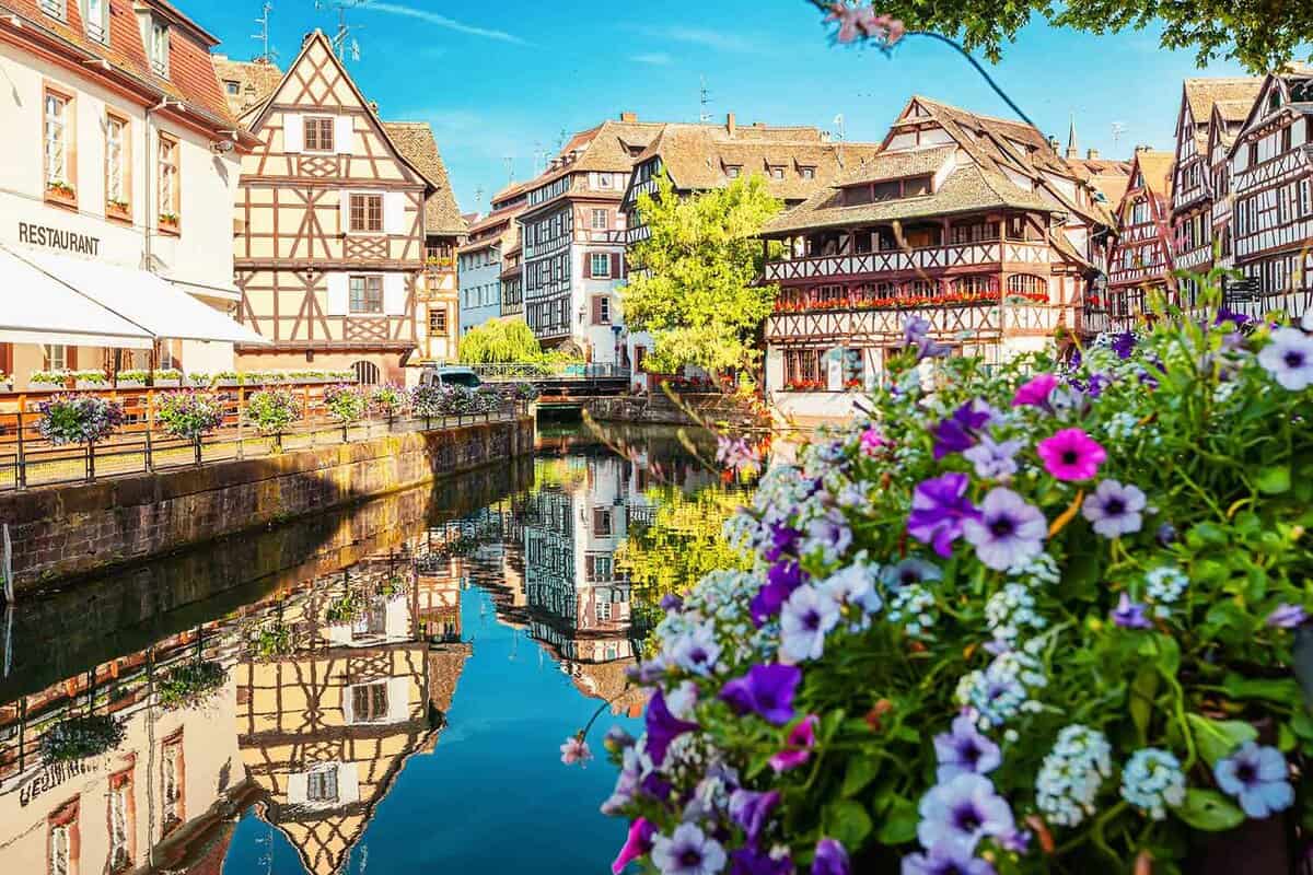 picturesque scene of colourful timber houses by a river