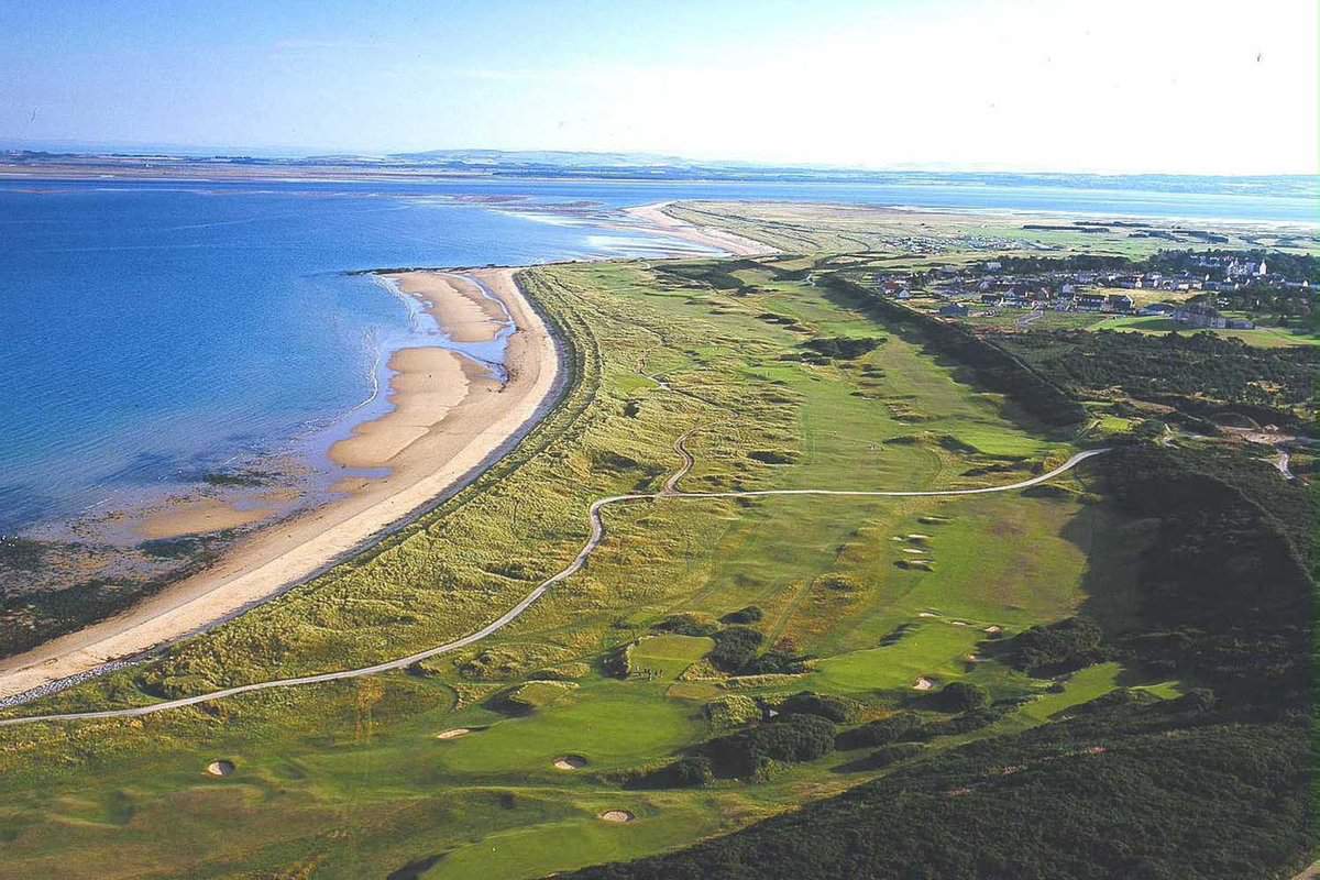 Aerial view of the course alongside a sandy beach and coastline