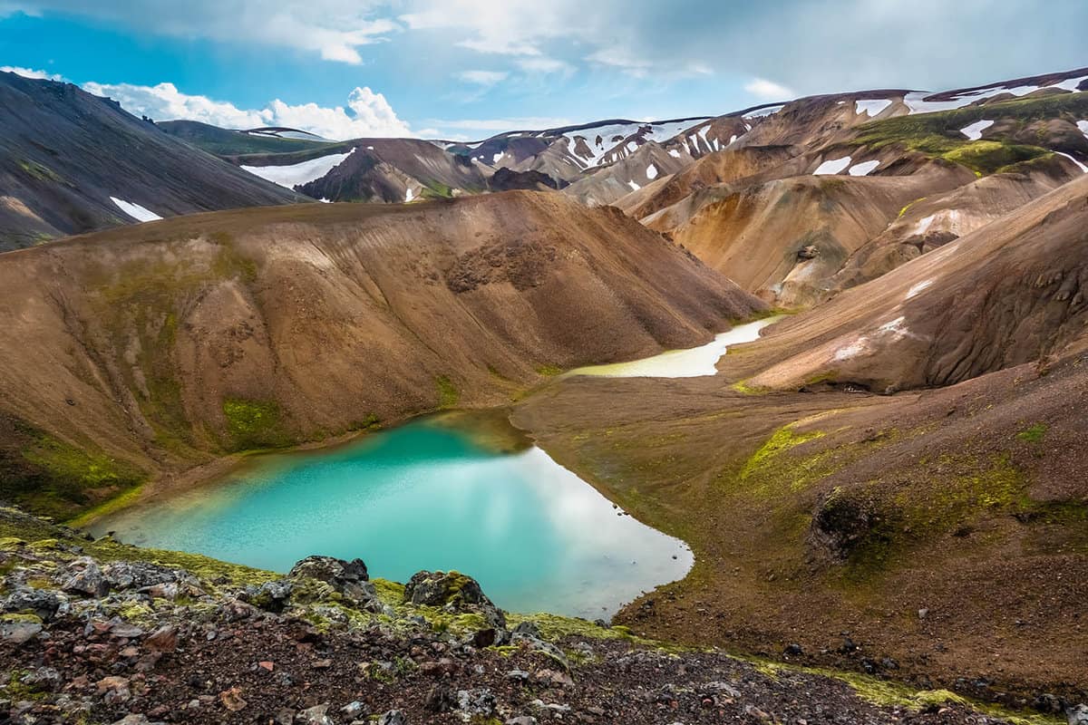 Emerald colored glacial lagoon in the midst of the surreal landscapes near Landmannalaugar along the Laugavegur hiking trail, Highlands of Iceland