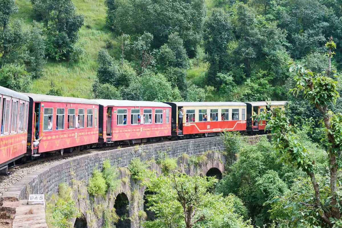 Kalka-Shimla Train travelling on a forested hillside