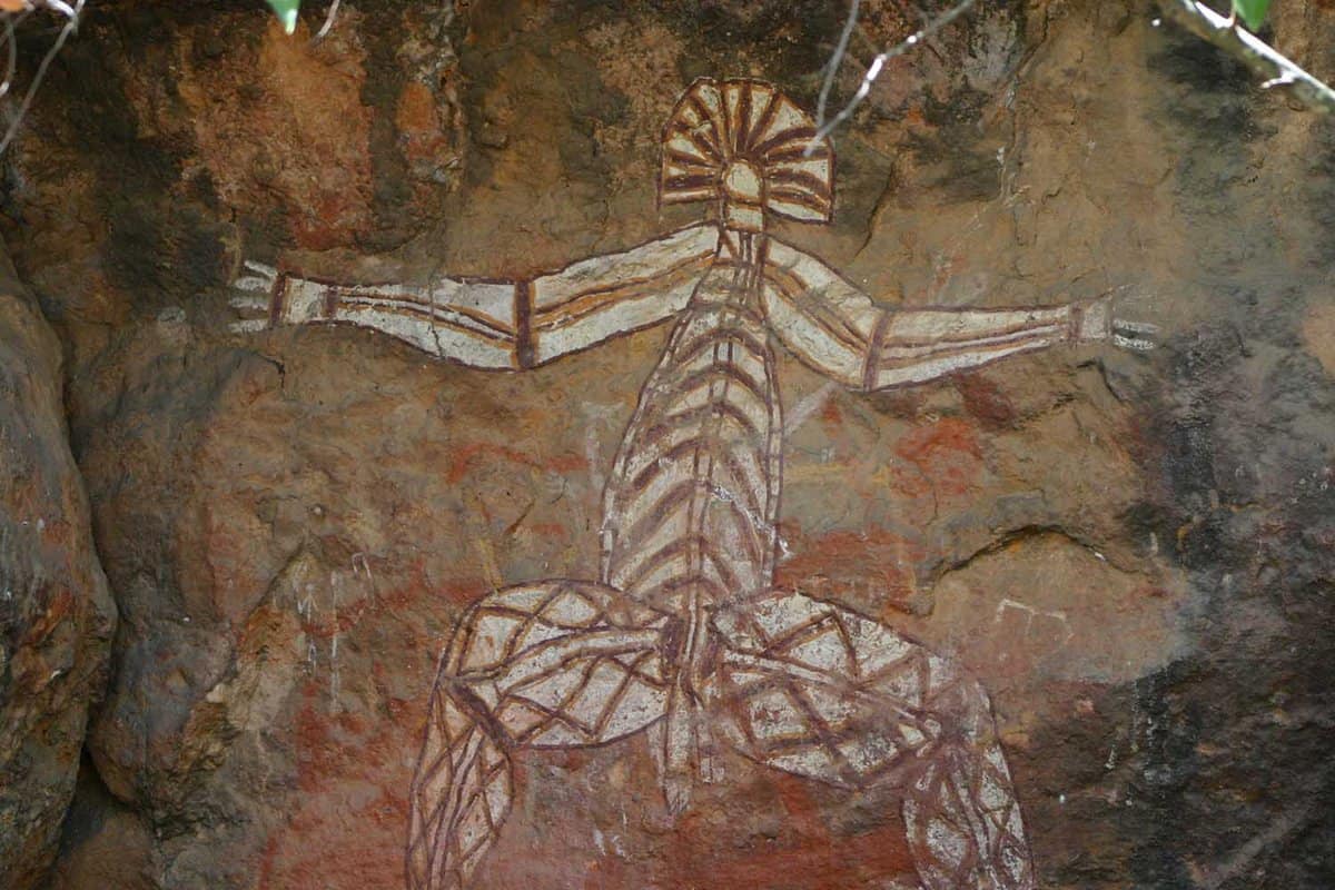 Close up of a white aboriginal painting of a god on a rock